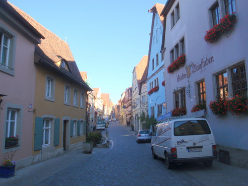 A flowery view up a street.